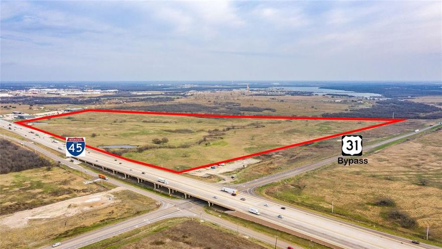 Large Acreage and Road Frontage on IH45 and the new Highway 31 Bypass! Just south of Corsicana outside the City limits. Property is the North East Corner of the IH45 and Highway 31 Bypass intersection.  Great Location for your growing business, or bring any and all development Ideas!  Combined Road frontage of just over 5700 Ft.  City waterline runs along the front of the property. Ag Exempt Taxes! Property is fenced for Cattle, and plenty of water with two ponds and creek running through the property. Great property with multiple options for development or your growing Business. Corsicana is a growing area just 55 miles south of Downtown Dallas on your way to Houston.