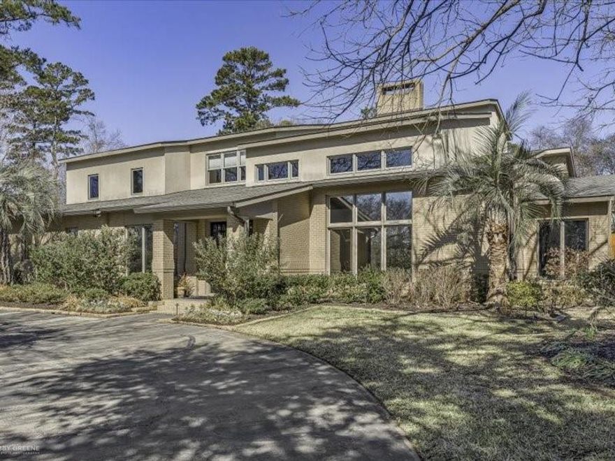 Located in the sought-after, gated community of Long Lake Estates, this custom contemporary home offers refined design, generous scale, and resort-style living. Built by Kirby Cole, the residence spans 5,568 square feet with 3 bedrooms, 3 full baths, and 2 half baths, designed for both everyday comfort and elegant entertaining. The living room impresses with soaring ceilings, abundant natural light, a fireplace, wet bar, custom built-ins, and expansive windows overlooking the front yard. A private den with built-ins sits just off the living room, while an oversized formal dining room connects seamlessly to the kitchen. The chef’s kitchen features an oversized island with seating, stainless steel appliances including separate built-in refrigerator and freezer, gas and electric cooktops, double ovens, a butler’s pantry, and two walk-in pantries. The adjoining family room offers wood floors, a fireplace, and a wall of windows overlooking the backyard. A study off the family room includes built-ins, a closet, and backyard views.
The first-floor primary suite is a true retreat with a fireplace and views of the pool and backyard. The spa-like primary bath offers separate vanities, a steam shower, whirlpool tub, and custom walk-in closet. Upstairs, two additional bedrooms feature walk-in closets and ensuite baths, along with a game or bonus room. Outdoor living includes a covered patio, outdoor kitchen, heated pool, hot tub, and water features. Additional highlights include a three-car garage, golf cart garage or workshop, generator, attic storage, and circular drive. See private remarks for what remains