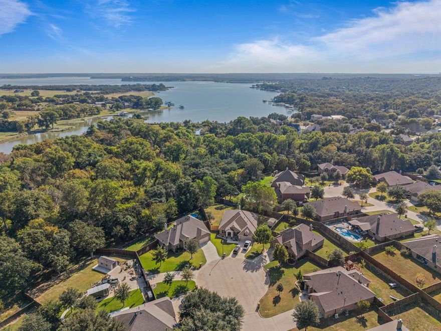 Gated neighborhood, Azle ISD, just blocks from Eagle Mountain Lake with quick access to Hwy 199! Tucked away on a quiet cul-de-sac and surrounded by a peaceful wooded backdrop, this home offers both privacy and convenience. With 2,466 sq. ft. of thoughtfully designed living space, the layout features 4 spacious bedrooms, 3 full baths, and an open-concept kitchen, living, and dining area perfect for everyday living or entertaining. The first-floor primary suite is complemented by two additional bedrooms and a full bath, providing ideal main-level living. Upstairs, you’ll find a fourth bedroom, full bath, and a flexible bonus space that can serve as a game room, guest suite, or in-law retreat. The well-appointed kitchen showcases new KitchenAid stainless steel appliances, a large center island with seating, walk-in pantry, and abundant cabinet storage. The living room features a cozy wood-burning fireplace, while new carpet enhances all bedrooms and the upstairs area. Located just 16 miles from Dickies Arena, 14 miles from the historic Fort Worth Stockyards, 15 miles from the Cultural District, and 33 miles from DFW Airport, this home offers the perfect balance of quiet neighborhood living and easy city access. Nestled within a gated community near shopping, dining, and recreation, this home truly blends comfort, privacy, and convenience. **Refrigerator, washer, and dryer are included—making move-in day a breeze!