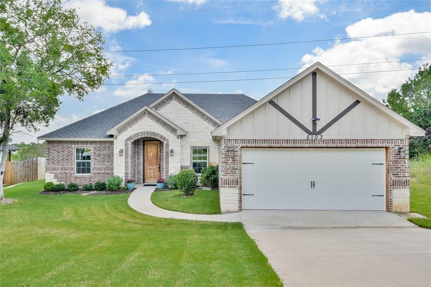 Positioned on a peaceful street, this thoughtfully designed home blends functionality with style. The open-concept layout is highlighted by custom cabinetry, gleaming granite countertops, stainless steel appliances, a spacious island, and a striking modern electric fireplace. A vaulted ceiling with an exposed beam spans the living area, adding warmth and architectural interest. The split-bedroom floor plan offers privacy and comfort, with a serene primary suite featuring dual sinks, a large walk-in shower, and custom cabinetry. Energy efficiency is top-of-mind with spray foam insulation and a radiant barrier, helping to keep utility costs low year-round. This is more than a house—it’s a place to truly feel at home.