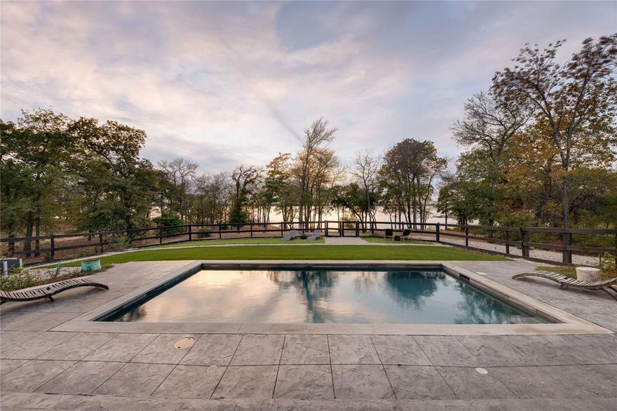 Welcome to 1180 Oak View Ct. in the revered Eagles Landing subdivision. Nestled on 1.7 acres with significant Lake Lewisville frontage, this colonial masterpiece radiates New England allure. Merely 2 miles from both the polo and yacht clubs, it's positioned for the discerning enthusiast. Crafted for lakefront elegance, interiors showcase design celebrating water views. Dual offices and two primary suites—one on each floor—cater to luxury and seclusion. The upper screened patio is a sanctuary for yoga, sipping wine, or reflecting by the lake. The 5th bedroom's adaptability makes it apt for media or play, and generous storage graces the home. It stands out in energy efficiency thanks to foam insulation. Outside, an inviting pool, outdoor shower, and verdant gardens with fresh produce await. A private beach and rock perch provide peaceful lakeside respites. 1180 Oak View Ct. isn't just a residence; it's an embodiment of upscale living, blending luxury, accessibility, and nature.