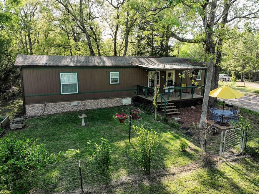 Welcome to your very own private NE Texas 2 bedroom, 2 full baths, water-view retreat in Hickory Hills on 2 treed lots, a POIA subdivision on Callender Lake.  The home is 864 sq. ft. which is just perfect for a practically maintenance free dwelling.  It's approximately a 1.5 hr. drive from Dallas, perfect for weekenders, or those wanting to finally retire from city living.  Callender Lake is a beautiful 365 ac. spring fed lake, stocked full of large-mouthed bass, catfish and crappie for your boating and fishing pleasures.  Laidback, away from the rest of the world, the TWO treed lots and home with a circular driveway will provide you plenty of much desired personal privacy.  This well maintained 2016 Champion manufactured home, faces away from the street, and toward a great view of the water, public fishing pier and swimming area.  There is ample storage room in the large add on pantry if you want to stock up.  You can perch yourself up on the elevated, breezy front porch for hours of peace and enjoyment with a great view of your very own private yard and water view.  Enjoy bird-watching, gardening, outdoor dining and entertaining.  Delight in annual purple and yellow irises, succulent strawberries, blackberries, plums, grapes and veggie container garden beds.  You can even start your own seedlings, or just overwinter pot plants in the charming small greenhouse.  Two storage buildings provide plenty of storage for garden tools and lawnmower etc.  For your safety in a storm, the property provides a roomy in ground storm shelter with a built in bench.  If you are seeking great little get away or a permanent lake view property, this is it!  Window coverings, wall hanging TV, front loading washer and dryer, stove, and fridge, all stay with the property.  This little gem on two large lots is move in ready!   The community has a pool, children's park, boat ramp, fishing pier, lake swim area, shower and restroom facility for your use.  Come see this great property today.