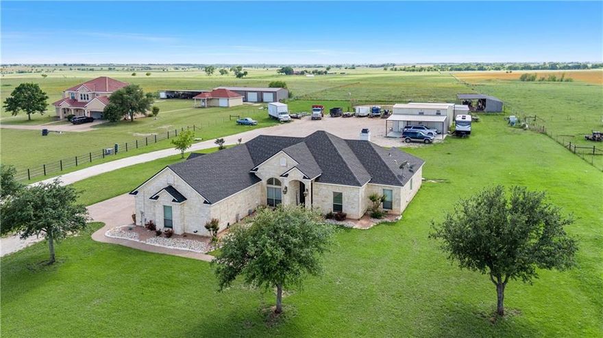 Embrace the country lifestyle in McGregor, Texas! This Whitestone home on 5 acres offers the perfect blend of serenity and space. Your ideal country retreat awaits. Built in 2010, this home has an open floor plan you will love! Living room features high tray ceilings, enjoy the stone wood burning fireplace, granite on all windows, & new light fixtures. The kitchen overlooks the living room and backyard, Beautiful custom kitchen cabinets with matching granite, & high-end appliances. Comes with a Breakfast nook & a formal dinning area. 3 bedrooms, plus an office & 2.5 bathrooms just in the primary residence. Master bedroom is Isolated, master bathroom has both stand-alone marble shower and whirlpool tub, granite & sitting vanity with a walk in closet. Spacious laundry room with cabinetry & sink. Spacious foam-insulated garage, finished out, featuring central heat(furnace is new) & Air is - an ideal space for a game room measuring 568 sq. ft. Enjoy the comfort and versatility in this thoughtfully designed area. Explore the possibilities with a huge foam-insulated workshop, with electricity, attached garage, and versatile living spaces. Downstairs, find a one-bedroom, one bath suite, and upstairs, a full apartment including kitchen. There is also an RV- covered parking area with hook-ups for an RV. Outside, discover horse stables, multiple metal stalls, and a coral for an added touch of country living. Huge untapped potential for the land towards the back of the property. PLUS -  A New Roof installed 2024!!