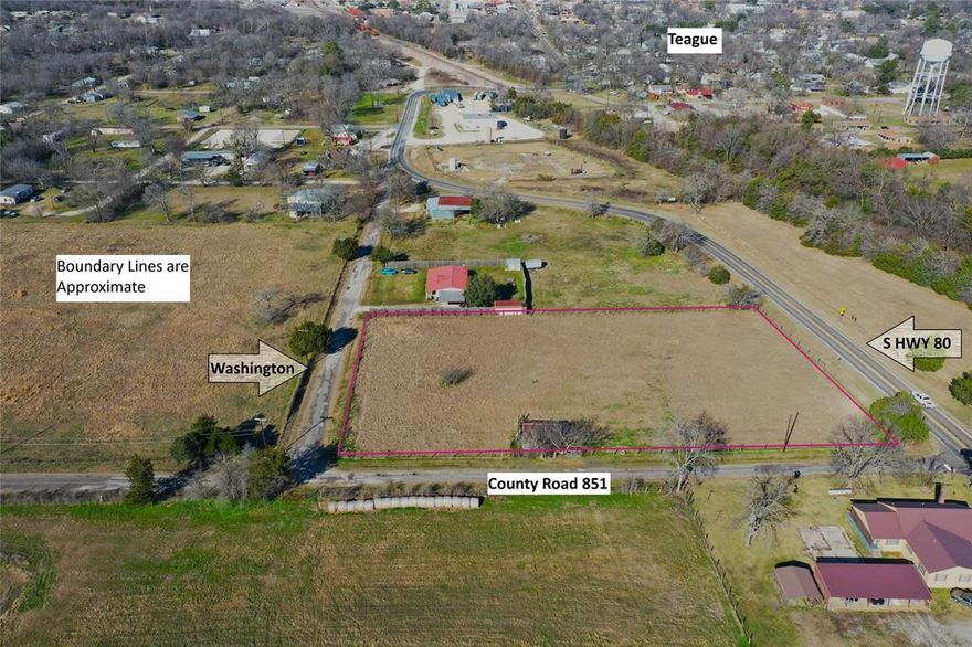 Beautiful, open, approx. 1.8 acres with road frontage on three sides. Within the city limits, but with plenty of elbow room!  Easy access from each side gives you alot of flexibility for arranging structures to fit your needs.  Perimeter fenced & rustic barn with lean to.  Ag exemption in place.  Limited to one single family residence, no mobile or manufactured homes, no RVs.  Please see deed restrictions. Seller to reserve mineral rights.