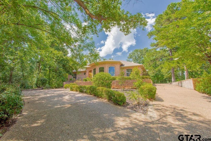 PRICE REDUCED TO $394,500!!! Set on a beautifully landscaped, oversized, 1 plus acre lot, this charming traditional home offers space, comfort, and endless potential. With three generous bedrooms and two and a half bathrooms, there's room for everyone to spread out and feel at home. Step inside to find a cozy, welcoming atmosphere. The expansive living room flows into a large dining space, perfect for hosting family dinners. A second living area boasts vaulted ceilings and a woodburning fireplace, perfect for chilly nights. The kitchen is loaded with features including granite countertops, ample cabinet space, double ovens, electric cooktop, large pantry, and a breakfast nook. Right off the nook is a handy home office area leading to the back patio. Home has a mix of tile, wood flooring, and carpet, lots of storage spaces, and two cooling systems to keep things comfortable. The primary bedroom is spacious and includes a private bath with garden tub, separate shower, walk in closets, and access to back yard. The backyard has mature trees, winding walkways, charming bridge shared with the neighbors and also a garden spot! The generous yard provides room for a pool, a guest suite, or your dream workshop. The circular driveway in front offers ample parking. Hideaway offers golf, swimming, boating, tennis, pickleball, playgrounds for the kids, and a great lodge with restaurant. Hideaway is a gated community offering safety for your family. This home offersprivacy and access to a vibrant community. Come make this home yours!