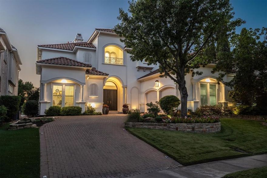 Experience refined Mediterranean-inspired living in this 4-bedroom, 4.5-bath custom home within the exclusive gated community of Fairway Vista in Las Colinas. Perfectly positioned on the 18th fairway of TPC Las Colinas, this residence offers a rare blend of sophistication, comfort & resort-style serenity. Designed with thoughtful flexibility, it features two primary suites—one on each level—ideal for guests or multi-generational living. From timeless architecture to panoramic golf course views, every detail reflects elegance & ease. Step inside the grand two-story entry, where a sweeping staircase sets the tone. Hardwood floors flow throughout, while automated window shades enhance light & privacy. A private office & formal dining room provide elegant spaces for work & entertaining. The rear of the home opens to a bright great room where soaring ceilings & walls of windows frame views of the sparkling pool & manicured fairway. The chef’s kitchen is a true centerpiece, featuring a generous island, built-in refrigerator, butler’s pantry with wine fridge, double ovens, refrigerator drawers & walk-in pantry. Upstairs, the owner’s retreat with spa-like bath is a private sanctuary with a sitting area that opens to the balcony for panoramic golf course views. Two additional bedrooms, each with ensuite baths, and a media room with wet bar complete the second floor. Outdoors, enjoy serene afternoons by the pool & spa as sunsets over the fairway create a setting of pure relaxation. This home blends resort-style living with refined everyday comfort—an exceptional opportunity in one of Las Colinas’ most coveted enclaves.