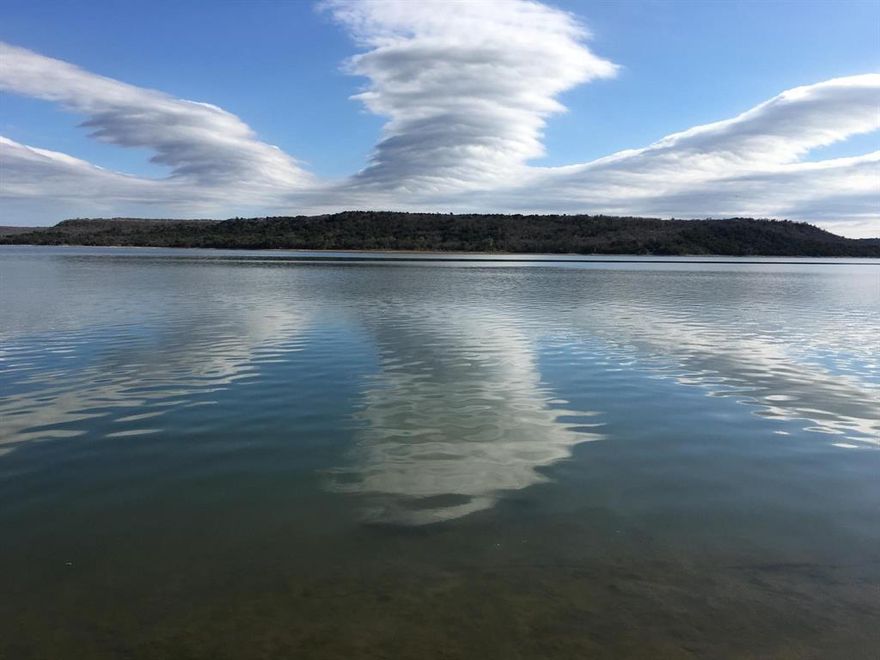 Situated on just over half an acre, Lot 218 at Clearwater Point offers an incredible opportunity to build your dream lake retreat in one of Texas' most celebrated destinations: Possum Kingdom Lake. Located on the scenic west side, this up-and-coming gated community is designed for both relaxation and recreation. Future amenities will include a resort style pool, multiple community gathering spaces, pickleball and basketball courts, a putting green, and pavilions for outdoor fun. Plans also allow for private boat docks, a community boat launch, and plenty of room to explore with miles of private paved roads ideal for walking, biking, jogging, or cruising in a golf cart. Each homesite will have underground electricity and co-op water installed at the front, making it ready for easy development. The setting is truly breathtaking; offering expansive views of the Palo Pinto Mountains, rolling hills, and dramatic sunsets. With shops and dining just a short drive away, and short-term rentals permitted, this property is perfect for a private escape or an investment opportunity. Come be part of Clearwater Point’s exciting future and make this tranquil slice of lake life yours. This is the newest gated community at Possum Kingdom and located on the west side of Possum Kingdom Lake . Perfect place to relax and get away .