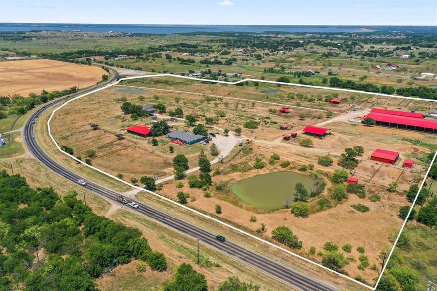 48.5-acre ranch on FM 2164 offering expansive views, multiple residences, and full equestrian facilities. This property is ideal for private use, boarding, or training operations.

Residences Total 5,413+ Sq Ft: Blue Home: Over 2,500 sq ft with 4 bedroom, 3.5 bathrooms.
Mobile Home: 1,510 sq ft open floor plan with 3 bedroom, 2 bathroom White House: 1,410 sq ft with 3 bedroom, 2 bathroom.

Equestrian Facilities:
110x220 covered arena 
Show Barn is 68x230: Spray-foam insulated with 27—12x12 stalls, 3 wash racks, tack room, feed room, office, and 2 restrooms.
Hay Barn with Mare Motel: Hay storage, 7, 10x10 stalls, tack room, and storage loft.
Additional Storage Barn: Overhang, tool room, and 6 stalls located between two homes.
Covered Round Ped

Land & Infrastructure:
3 large pastures, 2 smaller pastures, 5 turnouts with shade cloth, 3 paddocks, plus 5 paddocks with shelters.
2 wells, 3 ponds, and 2 gated entries.
A rare opportunity to own a fully equipped ranch with ample space, quality facilities, and flexibility for a variety of uses. Schedule your showing today.