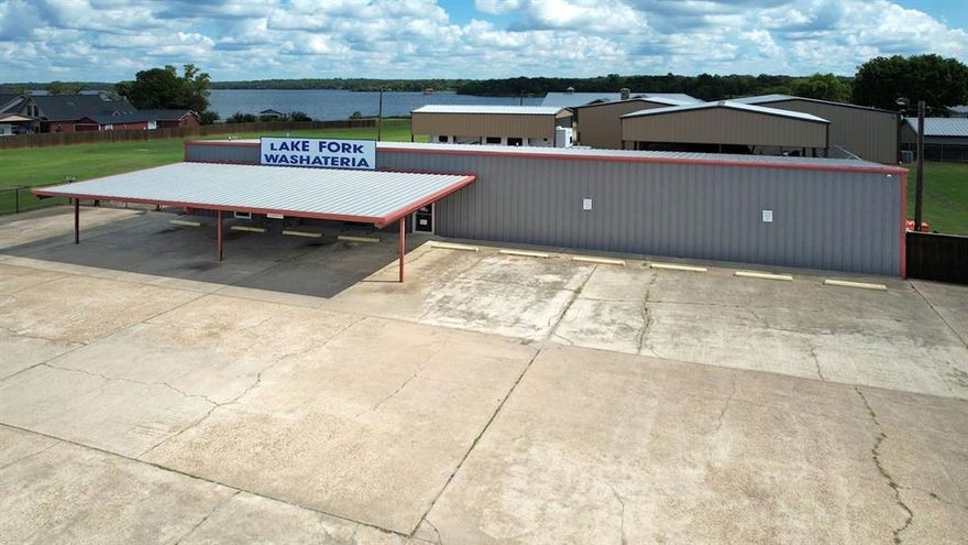 Here’s your chance to own a truly one-of-a-kind property on the world-famous Lake Fork in East Texas! This incredible offering includes both a 2,500 sq. ft. commercial washateria and a custom 3,800 sq. ft. waterfront home—perfect for business, pleasure, or both!  The commercial washateria is fully equipped and ready for operation. The property features two large metal carports and a metal shop with living quarters complete with a full kitchen—ideal for guests or extra storage for your lake toys. Behind the washateria sits a stunning custom-built 2-bedroom, 2-bath home designed for comfort and entertaining. With spacious living areas, modern finishes, and breathtaking waterfront views, this home is the perfect retreat after a day on the lake.  Enjoy direct lake access from your own private boathouse, making fishing or sunset cruises a breeze. Conveniently located near shopping, dining, and major East Texas cities and the DFW area, this property offers both investment potential and relaxed lakeside living.  Don’t miss this rare opportunity—schedule your private showing today and see all that this unique Lake Fork property has to offer!