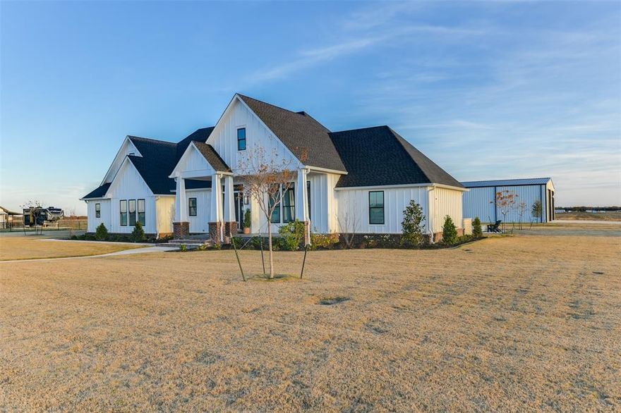 Luxurious Country Estate: Modern Living on 12 Pristine Acres
This exceptional custom residence offers the perfect balance of peaceful country living with sophisticated urban amenities. Virtually brand new, this remarkable home was occupied for only four months and presents in immaculate condition. Exquisite Interior Features include
* Elegant hand-scraped wood flooring throughout
* Primary bathroom with premium heated floors
* Gourmet kitchen featuring built-in commercial SubZero refrigerator
* Triple oven configuration for ultimate cooking versatility
* Professional-grade ventilation hood in kitchen and over the built-in patio grill
Luxurious Outdoor Living
* Remote-controlled screens on the covered patio
* Stunning pool area with sophisticated LED lighting system
* Robotic pool cleaning system for effortless maintenance
* Inviting fire pit for evening entertainment
* Professionally landscaped two acres with lush sod, 32 mature trees, and curated flowerbeds
 Premium 5,000 Square Foot Workshop and RV Storage
* Four remote-controlled overhead doors for RV accessibility
* Complete custom bathroom
* Washer and dryer connections
* Three 50-amp hookups (both 110v and 220v)
* Independent security system
* Full cable and internet connectivity
* Convenient RV dump station
Additional Property Highlights
* Impressive Austin stone entry with custom-built electric gate
* Propane service for pool heating, gourmet cooktop, fireplace, and backup generator
* Turnkey property ready for immediate enjoyment
This rare offering combines privacy and luxury with every modern convenience imaginable.