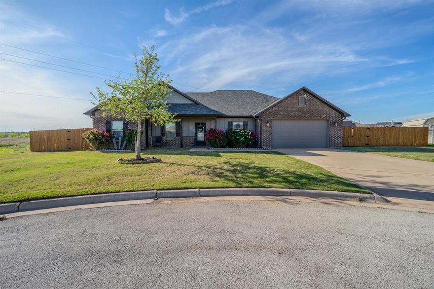 Discover your dream home in the highly sought-after Jim Ned School District! This spacious 5-bedroom, 2-bathroom property sits on just over half an acre, tucked away at the end of a peaceful cul-de-sac—perfect for those seeking privacy and quiet living. The open-concept layout creates a welcoming atmosphere, highlighted by new laminate flooring in the living area. The generously sized kitchen is ideal for entertaining guests or gathering with family. Step outside to a fenced backyard offering plenty of room for outdoor activities, pets, or future improvements. This home comes move-in ready with a refrigerator, washer, and dryer, plus mounted TVs in both the living room and primary bedroom—all conveying with the sale. Additional features include gutters and a sprinkler system for added convenience and ease of maintenance. Don’t miss your chance to own this inviting, well-equipped home in a fantastic location! {Information believed accurate but not guaranteed. Property sold “as is.” Acreage, maps & fence lines are approximate. Buyers should verify details. Subject to errors, changes, prior sale, or withdrawal.}