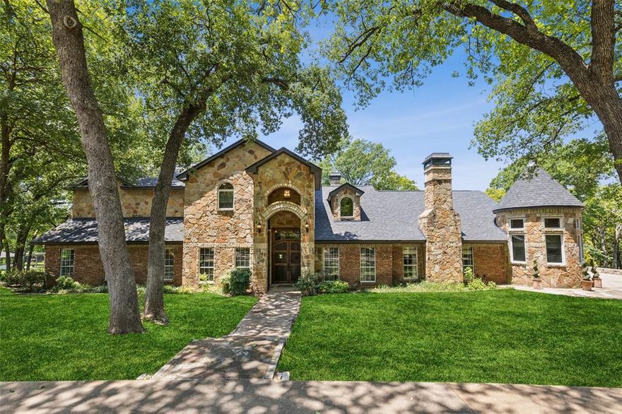Old World Elegance Meets Lakeside Luxury! Discover a truly unique and opulent 2.64 acre estate just 2 miles from downtown Weatherford 1 mile from I-20 and Costco and 25 minutes to Downtown Fort Worth. This architectural masterpiece is nestled on lush acreage along a tributary of the Trinity River, featuring three cascading lakes with 60-ton stone spillways. 5 bedrooms, 4.5 baths, and a rare blend of luxury materials—Terrazzo, Saltillo tile, marble, walnut, oak, and hand-carved wood—this home is both a fortress and a showpiece. Designed to blend seamlessly with its natural surroundings, the mansion boasts 63 custom, energy-efficient windows, three grand fireplaces, barrel-vaulted and frescoed ceilings, murals, and antique chandeliers. The gourmet kitchen is a chef’s dream, with high-end stainless steel appliances, a 14-foot two-tier granite island, Viking fridge, oven, mini fridge and warming drawer and bespoke cabinetry. Interior highlights include soaring ceilings, plank wood and mosaic flooring, leaded glass windows, double steel entry doors, and seven secure interior doors. Enjoy music throughout with an integrated indoor outdoor speaker system, and unwind in the owner’s retreat with panoramic views of the lakes, a jetted tub, and one of a kind mural hand-painted dome ceilings. Exterior amenities include a two-car garage with an unfinished man cave, stone patios, covered porches, decorative lantern lighting, and 168 mature trees. A universal irrigation system supports lake or city water. A true blend of history, artistry, and modern engineering—this property offers unmatched privacy, luxury, and craftsmanship.