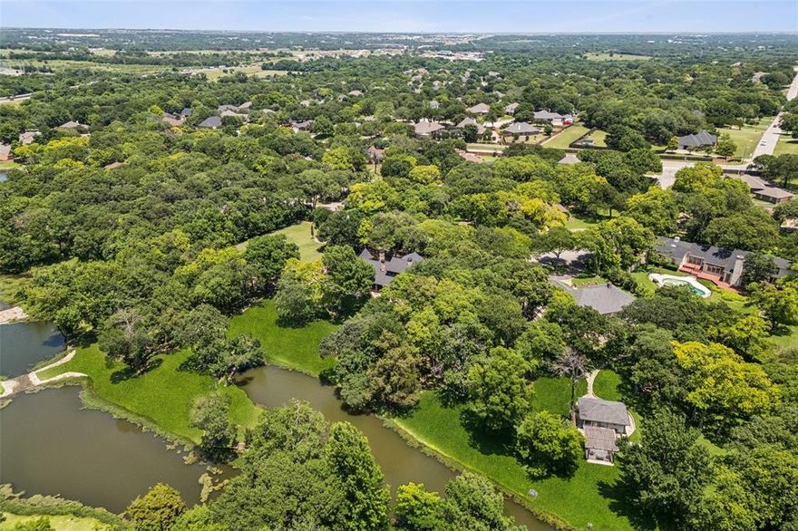Old World Elegance Meets Lakeside Luxury! Discover a truly unique and opulent 2.64 acre estate just 2 miles from downtown Weatherford 1 mile from I-20 and Costco and 25 minutes to Downtown Fort Worth. This architectural masterpiece is nestled on lush acreage along a tributary of the Trinity River, featuring three cascading lakes with 60-ton stone spillways. 5 bedrooms, 4.5 baths, and a rare blend of luxury materials—Terrazzo, Saltillo tile, marble, walnut, oak, and hand-carved wood—this home is both a fortress and a showpiece. Designed to blend seamlessly with its natural surroundings, the mansion boasts 63 custom, energy-efficient windows, three grand fireplaces, barrel-vaulted and frescoed ceilings, murals, and antique chandeliers. The gourmet kitchen is a chef’s dream, with high-end stainless steel appliances, a 14-foot two-tier granite island, Viking fridge, oven, mini fridge and warming drawer and bespoke cabinetry. Interior highlights include soaring ceilings, plank wood and mosaic flooring, leaded glass windows, double steel entry doors, and seven secure interior doors. Enjoy music throughout with an integrated indoor outdoor speaker system, and unwind in the owner’s retreat with panoramic views of the lakes, a jetted tub, and one of a kind mural hand-painted dome ceilings. Exterior amenities include a two-car garage with an unfinished man cave, stone patios, covered porches, decorative lantern lighting, and 168 mature trees. A universal irrigation system supports lake or city water. A true blend of history, artistry, and modern engineering—this property offers unmatched privacy, luxury, and craftsmanship.