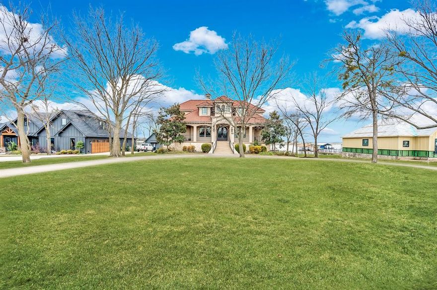 Positioned on a premier Richland Chambers Lake peninsula, this custom Mediterranean-style waterfront estate delivers commanding lake views, enduring construction, and resort-level outdoor living. With approximately 108 feet of shoreline, a steel retaining wall, concrete walkway, and private boat dock, this property offers true deep-water enjoyment—not seasonal access. Built on a drill-pier foundation with a concrete basement and metal decorative tile roof, the home was designed for longevity as much as luxury. The elevated setting captures sweeping water views from multiple balconies and outdoor living spaces, creating a front-row seat captivating views. The interior was extensively remodeled in 2022, including the kitchen, main living areas, primary bedroom and spa-style bath, updated bathrooms, new wood flooring, upgraded kitchen appliances, and fresh carpet upstairs. Two tankless water heaters support both everyday living and large-scale entertaining. The main level features a spacious living room anchored by a fireplace, dining room, wet bar, and a well-appointed kitchen with pantry—ideal for hosting. The primary suite offers private outdoor access and serene lake views. Upstairs, additional bedrooms, a media room, and expansive family room provide flexible space for guests and gatherings. The ground level mudroom adds exceptional utility area with full size washer and dryer area, storage, a full bathroom and an attached two-car garage. Outdoors, the property truly shines: tree-lined lot, oversized backyard, firepit, outdoor kitchen, fireplace, multiple balconies, and seamless access to the dock and shoreline—built for year-round enjoyment. Located within a gated lake community offering a resort-style pool, clubhouse, fitness center, and private fishing pond, this home combines privacy, amenities, and unmatched lake frontage. This is not a weekend cabin. This is a legacy waterfront home positioned on one of the best stretches of Richland Chambers Lake.