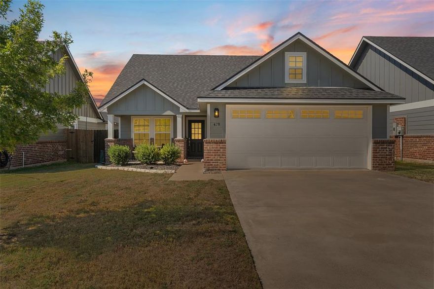 Welcome to this stunning open-concept 3-bedroom, 2-bathroom home in McGregor, TX!  Nestled in a newer, well-kept subdivision with sidewalks and streetlights, this home offers both comfort and modern style. Step inside to find a spacious living area centered around a large wood-burning brick fireplace — perfect for cozy evenings with family and friends.
The kitchen is beautifully designed with custom cabinetry, granite countertops, stylish backsplash, and stainless steel appliances — all included! The large island offers extra seating with space for bar stools, making it ideal for entertaining or casual dining. You’ll love the modern flooring, recessed lighting, and foam insulation that helps keep the home energy efficient.

The primary suite is your own private retreat, featuring dual vanities, a walk-in shower, a relaxing garden tub, and a large walk-in closet. The home also includes a nicely sized laundry room for added convenience.

Outside, enjoy front and back covered porches, a fully fenced backyard for complete privacy, and even a doggy door for your furry friends. The automatic sprinkler system covers the front, sides, and back of the property — making lawn care effortless!

Located just minutes from a community park, local restaurants, and shops, this home truly has it all — modern comfort, thoughtful design, and an unbeatable location!