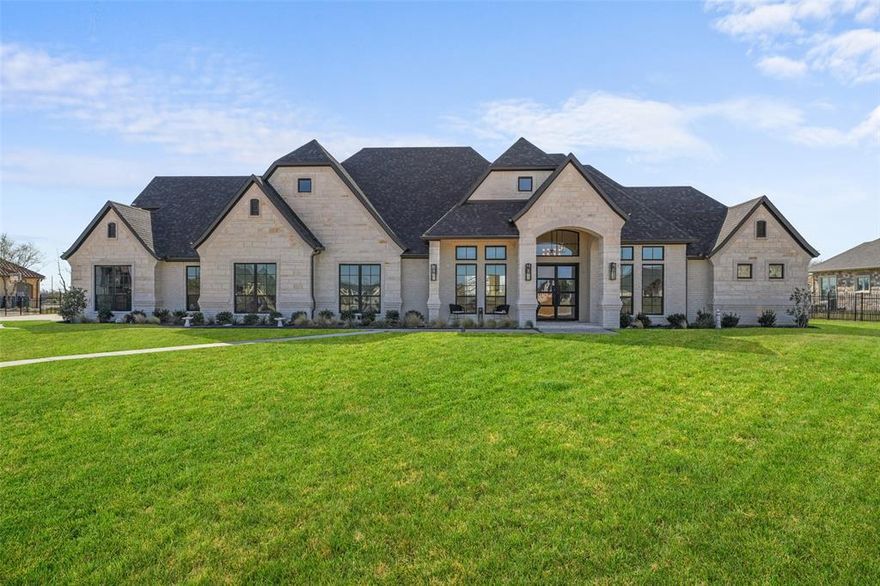 Welcome to luxury living just outside Rockwall in the premier gated community of Kingsbridge. This stunning 2024 build blends elegance, comfort, and modern design on the Heath side of Lake Ray Hubbard, just minutes from Downtown Rockwall.

Three of the four spacious bedrooms feature private ensuites, offering ideal privacy and functionality for family and guests. The open-concept layout is filled with natural light and enhanced by high-end finishes, creating a seamless flow throughout. Originally designed and built as the personal home of a custom builder, no expense was spared in quality or craftsmanship. The gourmet kitchen features top-of-the-line appliances, an oversized built-in Fisher & Paykel double-door refrigerator, designer quartz countertops, a grand island, and abundant backlit cabinetry—perfect for entertaining and everyday living.

The primary suite is a true retreat with a spa-inspired bathroom, including a freestanding tub and double-entry shower. His and hers walk-in closets are generously sized and finished with real wood and double-hung custom racks.

Upstairs offers a versatile recreational space with a half bath, ideal for a media room, game room, or private guest retreat.

Step outside to a backyard designed for entertaining. The custom pool includes heating and cooling for year-round comfort, with lighting synchronized to the firepit for a stunning evening ambiance. Additional features include a waterfall, putting green, and outdoor fireplace, all overlooking rolling meadows.

Located in one of Rockwall’s most desirable areas, this home offers peaceful suburban living with convenient access to shopping, dining, top-rated schools, and major routes to Dallas. This is more than a home—it’s a lifestyle.