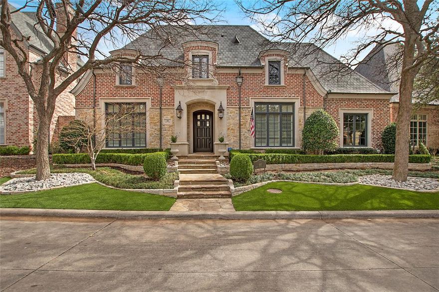 Nestled in the heart of Dallas’ most coveted enclave of Glen Abbey, 44 Abbey Woods Lane is more than a residence—it’s a love story written in brick, glass, and light. From the moment you enter the guarded and gated community, a sense of quiet sophistication surrounds you, but it’s not until you step inside this elegant estate that the magic truly begins.

Every inch of this home is a delicate dance between classic charm and modern luxury. Sunlight pours through tall windows, casting a golden glow on rich hardwood floors and coffered ceilings. The gourmet kitchen feels like the perfect setting to share coffee on quiet mornings. 
In the dining area, a stunning climate-controlled wine cellar becomes the heart of every gathering—a glass-encased jewel box where your finest vintages wait patiently for just the right moment. Imagine lingering dinners that stretch into the night, each course paired perfectly with a bottle from your private collection, each toast echoing with laughter and love.
Step out onto the patio and you’re greeted by a lush, private oasis—ideal for al fresco dinners under string lights or heartfelt conversations by the pool as stars shimmer above. The primary suite is a sanctuary of calm, complete with a spa-inspired bath.
Whether you’re entertaining in the formal dining room or cozying up by the fireplace in the living area, 44 Abbey Woods Lane doesn’t just offer a place to live—it offers a place to fall in love, every single day.