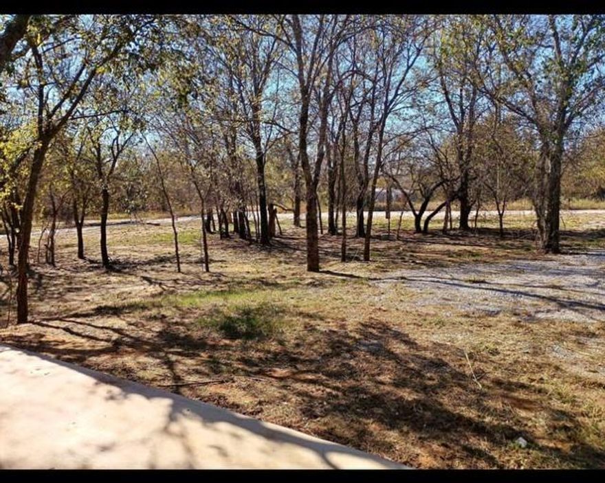 Discover the perfect opportunity in Runaway Bay! This unique property combines two adjoining lots into one expansive corner lot totaling over half an acre, offering endless possibilities for your next home or getaway. The land is beautifully treed, providing natural shade and privacy, and is already partially developed with several valuable improvements in place. 
A 30' x 40' RV cover with slab, 200-amp electrical service, and an existing septic system give you a strong head start on building or setting up your RV. Co-op water is available to bring onto the property, making future construction or utility setup convenient and cost-efficient. With no deed restrictions, you have the freedom to build your dream home, place a manufactured home, or bring your RV - whatever fits your lifestyle. 
The property is located outside of the city limits, so no city taxes apply, and it benefits from a very low tax rate of just 1.2448 - a rare find that adds long-term affordability to this already attractive investment. 
Nestled in the charming community of Runaway Bay, you're only five minutes from the lake, perfect for boating, fishing, or relaxing by the water. Enjoy no HOA, plus the added perk of being just minutes from the scenic Runaway Bay Golf Club & Resort. 
This oversized corner lot offers space, flexibility, and a hard-to-find mix of improvements already in place. Sellers are open to all offers - come see the potential this beautiful property has to offer!