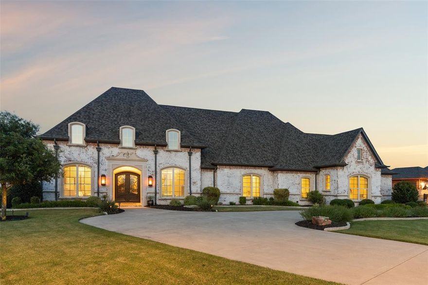 Exquisite Dave R. Williams custom estate situated on a pristine 1-acre lot in the prestigious gated community of Christie Farms, located within the award-winning Prosper ISD. This meticulously maintained home blends timeless design, modern functionality, and exceptional craftsmanship. The heart of the home is a chef’s dream, featuring a one-of-a-kind grand piano–shaped island, high-end appliances, custom cabinetry, and a full prep kitchen ideal for entertaining. The open layout flows effortlessly into spacious living, dining, and entertaining areas including a media room and game room. A full mother-in-law suite with private living space offers comfort and privacy for guests or multigenerational living. The primary suite is a luxurious retreat with spa-inspired bath, his-and-her custom closets, and a bonus flex room ideal for a gym, nursery, or reading lounge. The executive office is a true showpiece with 100-year-old reclaimed wood barn doors and built-ins, while a nearby sound-insulated room provides quiet rest—perfect for night-shift professionals or creatives. Step outside to your resort-style backyard featuring a sparkling pool, expansive patio, and a fully equipped outdoor kitchen—perfect for enjoying iconic Texas sunsets. Additional highlights include an oversized laundry room with built-in storm shelter and an expanded Texas basement offering incredible versatility as a teen retreat, podcast studio, or future additional bedroom and bath. No detail has been overlooked in this extraordinary home that truly defines luxury living in Prosper.