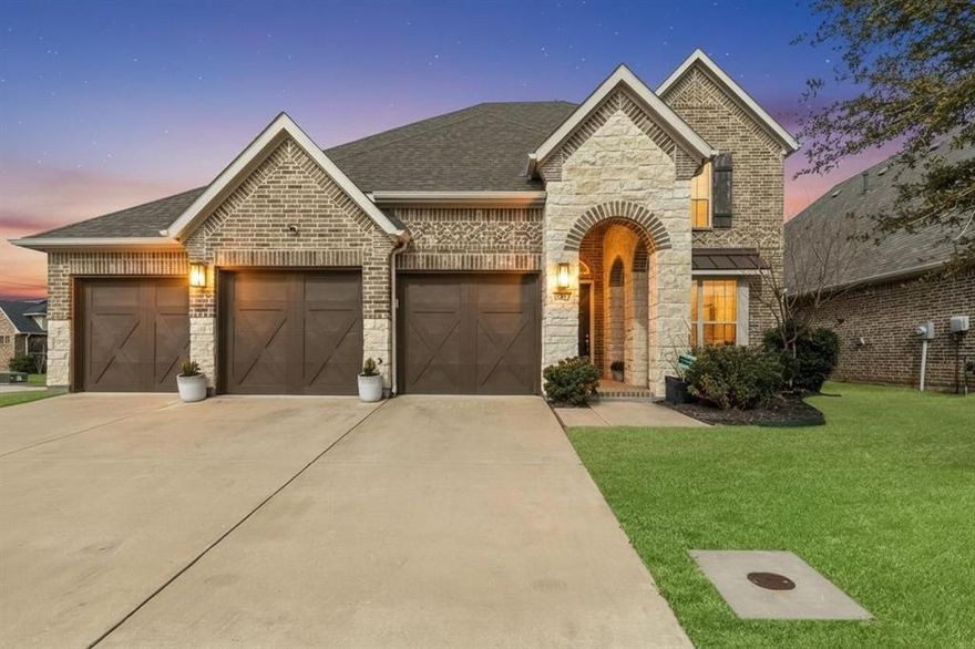 OPEN HOUSE ON 02.22 SUNDAY AT 1-3PM! *3-CAR GARAGE!!*ARGYLE ISD!!*CORNER LOT!*4 BED + OFFICE + GAME ROOM!*
Located in the highly desirable Canyon Falls community and zoned for acclaimed Argyle ISD, this beautifully designed 4-bedroom, 3.5-bath home offers refined living in one of the area’s most sought-after master-planned neighborhoods. Situated on a spacious corner lot with generous yard space, this home welcomes you with soaring 20-foot ceilings in the main living area, abundant natural light, and a dramatic floor-to-ceiling stone-look fireplace with gas logs. Luxury Vinyl Plank flooring flows throughout the main living areas, complemented by modern recessed lighting and a seamless open-concept design ideal for both everyday living and entertaining. The kitchen showcases a sophisticated modern aesthetic with two-tone cabinetry, crisp white upper cabinets, expansive quartz countertops, and a sleek subway tile backsplash. A large island with storage and breakfast bar anchors the space, along with an eat-in dining area featuring a built-in desk. Stainless steel appliances include a built-in gas oven and microwave, 5-burner gas cooktop with a vent hood. The dedicated office provides a private work-from-home retreat, while the upstairs game room offers additional flexible living space perfect for relaxing or hosting guests. The spacious primary suite features elegant tray ceilings, abundant natural light, and a thoughtfully designed ensuite bath with a garden soaking tub, oversized walk-in shower with tile surround and bench, and an expansive dual-sink vanity offering generous storage and counter space. All secondary bedrooms are located upstairs in a split floorplan layout, providing privacy and versatility. Residents of Canyon Falls enjoy resort-style amenities including multiple pools, scenic walking and biking trails, parks, a fitness center, and year-round community events—offering an elevated lifestyle in a premier location.