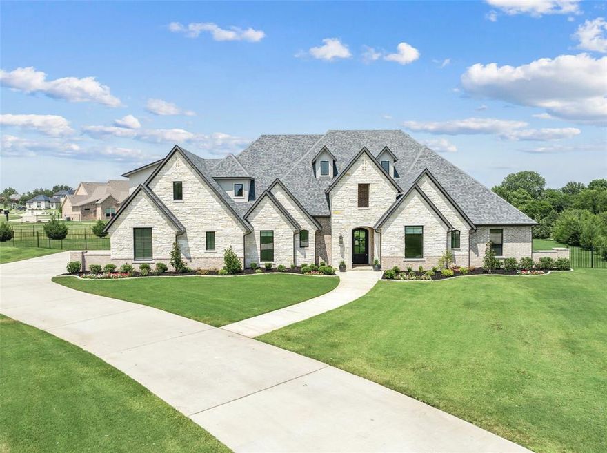 Welcome to this stunning J. Anthony custom home, a masterpiece of luxury and craftsmanship. Step inside to discover white oak floors that flow seamlessly throughout, creating a warm and inviting ambiance. The living area boasts vaulted ceilings and a breathtaking wall of sliding glass doors, flooding the space with natural light and offering panoramic views of the expansive 1.5 acre lot & fishing pond. The gourmet kitchen is a chef's dream, featuring a large island, Thermador range, 6-burner gas cooktop, and a spacious pantry. Enjoy meals in the nook with its built-in hutch and wall of windows. This home offers ultimate comfort with two primary suites and all bedrooms featuring private ensuite baths. A newly added bonus room upstairs provides versatile space for your needs. Located in the award-winning Lovejoy ISD, this property also includes an oversized 4-car garage with extra deep bay, perfect for car enthusiasts. Experience luxury living at its finest in this exceptional home.