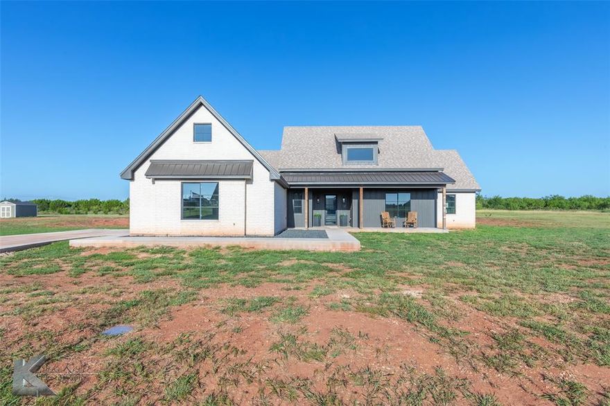 Here's your chance to own a luxurious new build by the unsurpassed luxury home building enterprise, Nelson Construction. Situated on almost 2 acres in highly desirable Jim Ned ISD. Just minutes from all that Abilene has to offer, yet outside city limits where you'll benefit from LOWER PROPERTY TAXES & NO HOA's. NOT in flood zone. Plenty of room to build a workshop, put in the pool of your dreams & enjoy all of the tree lined scenery with views of the hills. This home is pure luxe & ready for you to make it your very own oasis! Here's a list of some of the professionally designed & magazine worthy features to fall in love with: Large custom windows throughout, high-end commercial-grade gas range accompanied by high-end SS appliances in kitchen, quartz counters, huge 5x10 kitchen island, 12ft vaulted ceilings in main areas, designer lighting & fixtures throughout, soaring 20ft cathedral ceiling in master bedroom with exposed center beam, oversized 22x28 two-car garage, solid 8ft interior doors throughout, gas fireplace insert, mudroom with bench & lockers, Texas sized walk-in pantry & a layout worthy of envy. Main living areas are open concept with a split bedroom floorplan. The 4th bedroom could also make a great 2nd living area, den, in-law suite, home office, exercise room, media room or whatever you desire. The master suite is sensational! It's spa-like ensuite bath has a large walk-in shower with dual showerheads, including a rainfall showerhead, large soaking tub, dual sinks & a huge walk-in closet that anchors it all in. Lastly, for those that love being outdoors, you'll be impressed by the large, covered patio out back & the huge, covered porch in front. No more lots to build on out here - last chance to own in this highly desirable subdivision...hurry before it's too late! Call today for more info or for your exclusive showing.