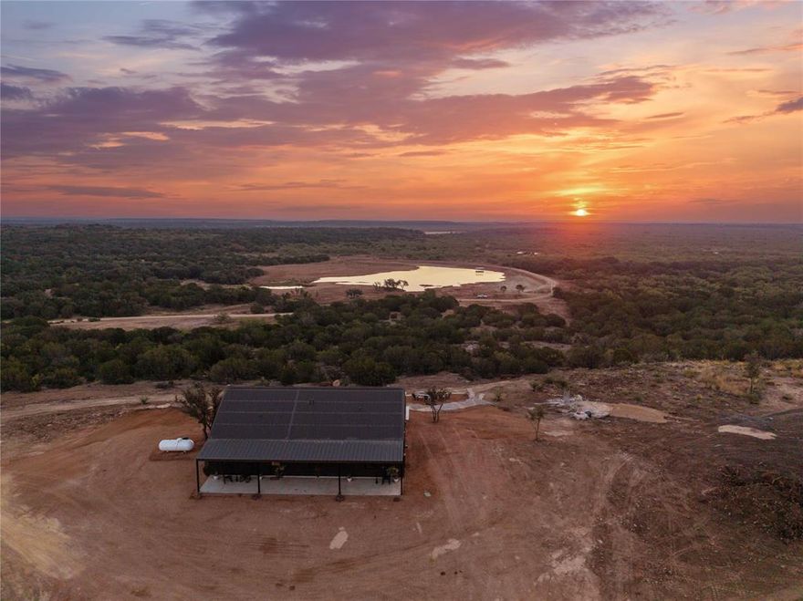 NEW LISTING – 420± Acre High-Fenced Ranch with 8+ Acre Lake & Barndominium 

Offered at $3,990,000.

420± acre high-fenced ranch located in Coleman County featuring rolling terrain with approximately 110 feet of elevation change, quality water features, and a newly constructed barndominium positioned on one of the highest elevations of the property.

The 1,500 sq. ft. custom barndominium includes 3 bedrooms and 2 bathrooms with an open-concept kitchen and living area, granite countertops, accent wood ceilings, spray foam insulation, metal roof, and durable plank flooring. Approximately 1,000 sq. ft. of covered porches include a full outdoor kitchen with grill, burners, sink, and stainless drawers. Additional improvements include a rock fire pit, dedicated golf driving pad, one-car garage for ATV storage, and a 70-yard cleared pad suitable for a future homesite. The home conveys fully furnished, including furniture, appliances, washer, dryer, TVs, linens, and kitchenware.

Utilities include Coleman County Co-op water and electric and hardwired internet via Coleman County Telephone Co-op.

Water features include an 8+ acre lake over 25 feet deep stocked with baitfish, floating dock with boat slip and fish habitat structure, three additional ponds (some stocked), and a pond near the home recently stocked with black-nosed crappie. The ranch consists of approximately 353± acres of live oak, post oak, mesquite, elm, hackberry, and cedar cover and 67± acres of cultivated wheat. Native sunflowers and dove weed provide seasonal bird habitat. All-weather gravel road from county road to improvements. Brand-new tight-lock perimeter fencing.

Wildlife includes dove, duck, turkey, and quail. Sale includes a $50,000 allowance for stocking improved whitetail and exotic genetics to be selected with buyer input and stocked in buyer’s presence.

Located approximately 8 miles south of Santa Anna and 29 miles southwest of Brownwood.