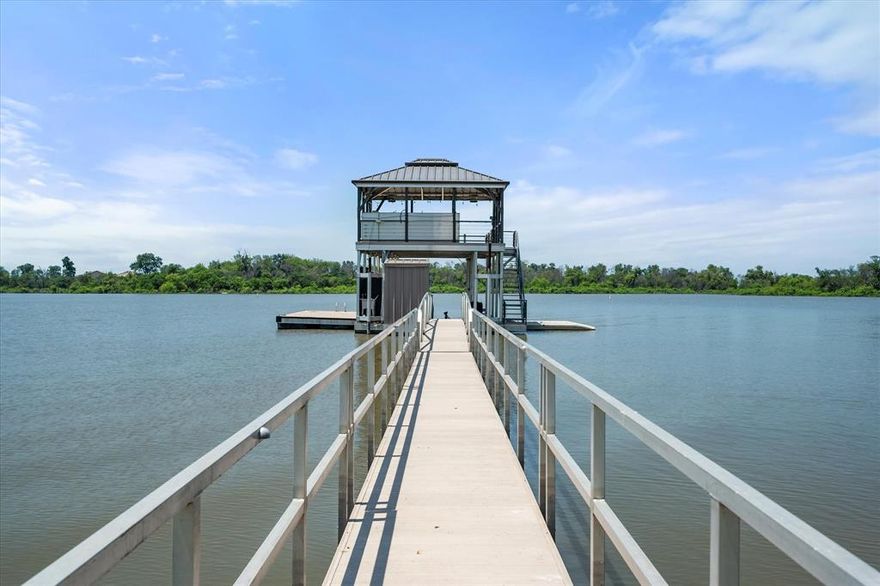 Lakefront Luxury Retreat on Eagle Mountain Lake. Experience the ultimate in lakeside living on this stunning 3.74 acre estate, located in an exclusive gated community just minutes from downtown Fort Worth. Boasting 650 feet of pristine water frontage on Eagle Mountain Lake, this exceptional property combines elegance, comfort, and resort-style amenities.
This custom crafted residence features 6 spacious bedrooms, 4 luxurious bathrooms, a dedicated office, and a flowing open concept living and kitchen area designed for entertaining. The gourmet kitchen is a chef’s dream, complete with granite countertops, a built in commercial refrigerator, double ovens, gas cooktop, oversized island, breakfast bar, expansive walk-in pantry, and a convenient butler’s pantry.
Thoughtfully appointed throughout, the home showcases hand-scraped wood floors, plantation shutters, custom chandeliers, and remote-controlled window shades. A mud bench area, large laundry room with built-in cabinetry, sink, and space for a second refrigerator provide everyday practicality. Upstairs, guest quarters with kitchenette and private balcony access offer the perfect retreat.
Step outside to your personal paradise: a covered patio with outdoor fireplace and misting system, built-in grill, fire pit, putting green, and a concrete walking, golf cart path from house leading to the water. The two-level dock features two jet ski ramps, tanning deck, and a boathouse equipped with a grill, sink, full-size refrigerator, water heater, and misters ideal for lakeside entertaining.
Additional features include a three-car garage, and is fully irrigated using lake water via a pump fed sprinkler system.
This is more than a home, it’s a lifestyle. Luxury, privacy, and recreation await at this one-of-a-kind Eagle Mountain Lake estate.