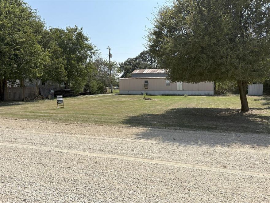 Cute Super Clean Two bedroom mobile home FURNISHED for a great retreat , or the perfect starter home.  New Carpet and flooring thru out.  Fresh paint in bathroom.  Sitting on a 2 lot track in China Spring ISD.  Gravel parking with RV 30 AMP Hook up ,  so bring a friend or family member. Kitchen has an open concept to living room with adorable eat at bar and pantry for plenty of storage area.  Large living room and spacious bedrooms.  House is furnished with nice clean living room furniture , bar stools, Entertainment center, Tv , Microwave , day bed, bedding , and more.    Lot is fenced on three side with additional fencing for a buyer to add for safety for children or pets.   Lonely Pine is dead end street so no worries about thru traffic, safe, quite and peaceful country setting.   Call today for your private showing.