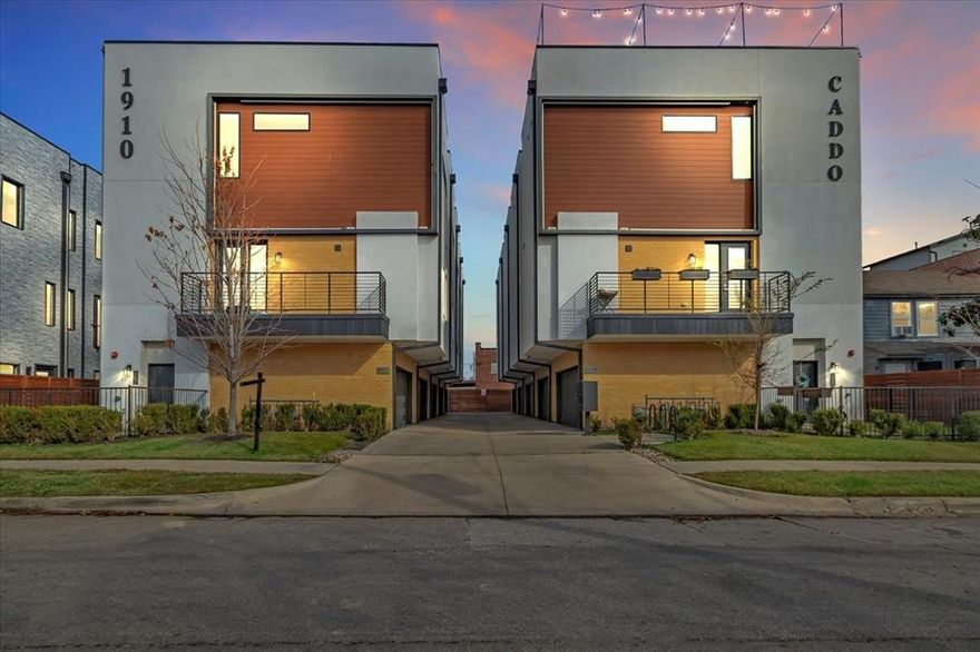 *Ask about special financing options on this unit.* Experience the pinnacle of sophisticated urban living in this stunning 2-bedroom, 2.5-bathroom end-unit condo situated in the vibrant heart of Dallas. This rare residence lives like a custom townhome, offering the perfect blend of luxury and privacy.  The heart of the home is a chef-inspired kitchen that serves as a masterpiece of both form and function. It features a large center island, sleek quartz countertops, and a premium gas range, all anchored by a convenient beverage fridge for effortless entertaining. This bright and airy culinary space flows seamlessly into the adjacent family room, creating an inviting atmosphere for daily living or hosting guests. For added convenience, a stylish powder room is located on the main level to serve the common areas. Beautiful hardwood flooring and elegant custom blinds are found throughout the spacious, open-concept floor plan.  The second floor is intelligently designed with two bedroom suites, each serving as a private sanctuary with its own dedicated ensuite bath and generous closet space. This dual-suite configuration offers maximum flexibility for a high-end home office, or guest quarters. What truly distinguishes this property from anything else in the city is the exceptional outdoor space. Residents can enjoy the rare luxury of a private, fenced side yard, in addition to an expansive rooftop patio. This sky-high oasis is finished with high-quality, low-maintenance turf, providing a serene environment for relaxing or hosting unforgettable gatherings with city views.  Complete with an attached two-car garage for secure parking and extra storage, this home offers the lock-and-leave convenience of a condo without sacrificing the amenities of a single-family residence. Located just minutes from the best dining, shopping, and entertainment Dallas has to offer, this property represents a unique opportunity to own a true urban sanctuary.