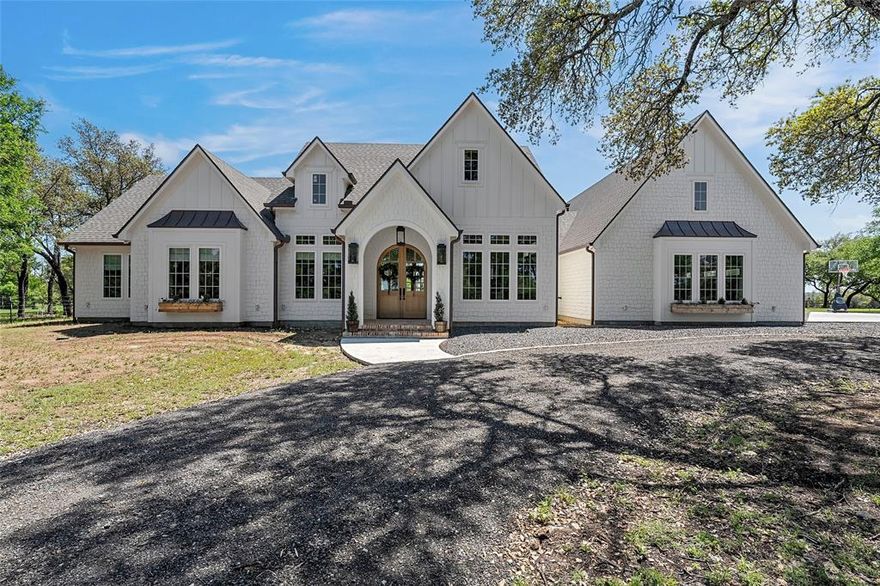This exquisite 'Modern Cottage' in Bosque County is a dream come true for anyone seeking luxury and tranquility! With 4 bedrooms and 4.5 baths, it's designed with meticulous attention to detail. The details from the moment you walk up to the front porch will leave you eager to see more. These capturing features include gas lanterns, copper gutters, Old Chicago brick, and stunning white oak double arch front doors. 

The kitchen is the focal point as soon as you walk into the main living space of the home. It is equipped with a 36 inch Thermador gas cooktop, Cafe dishwasher and double ovens, hand selected Tesoro marble countertops and backsplash, luxury lighting and a butler's pantry with built-in ice maker, perfect for culinary enthusiasts. The living room, with its soaring 12 ft ceilings and expansive windows, offers a breathtaking view of the surrounding oak trees, while the cozy gas fireplace adds warmth and charm.

The master suite is a true retreat, boasting vaulted ceilings and a spa-like bathroom featuring a cast iron freestanding soaking tub, Thassos marble flooring, and seamless marble flowing into the shower. The additional bedrooms are spacious and conveniently designed with ample closet space and built-ins, and en suite bathrooms that feature quartz countertops.

The thoughtfully designed laundry room enhances functionality, making chores easier with space for multiple machines and even a pet shower. Don't forget the 'dog bedroom' perfect for pet crates or simply use it for extra storage. 

Outdoor lovers will appreciate the extensive 28-acre property, complete with an outdoor kitchen, irrigation system, outdoor bathroom, wood-burning fireplace, and plumbed for a future pool. The large 60X60 shop with a 20X60 front and 20X60 back carport adds even more versatility, making it a perfect space for hobbies, extra vehicle space or storage. The shop also conveniently includes a bathroom and sink. 

You don't want to miss out on this one!
