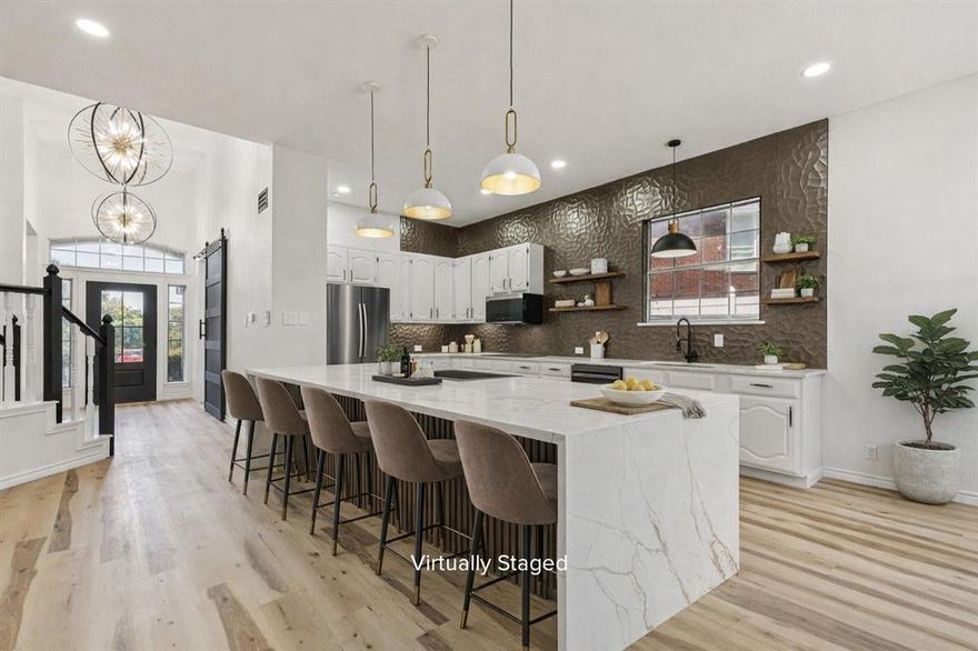 Welcome to 915 Inverness Circle, a fully remodeled gem in the heart of Highland Village. This stunning home has been thoughtfully redesigned with modern finishes and timeless details, creating a perfect blend of style, comfort, and functionality. The open-concept living area features soaring ceilings, abundant natural light, and a striking floor-to-ceiling fireplace with a sleek mantle, making it the centerpiece of the home. Gorgeous new flooring flows seamlessly throughout, leading into the chef-inspired kitchen. Here you’ll find a dramatic waterfall island, quartz countertops, custom cabinetry, designer tile accents, and upgraded pendant lighting, ideal for entertaining and everyday living. The spacious primary suite is a true retreat, offering a luxurious spa-like bathroom with a double vanity, oversized walk-in shower, and a custom-designed walk-in closet with built-ins for maximum organization. Secondary bedrooms are generously sized with fresh finishes, while the updated bathrooms offer modern tile work and fixtures. Step outside to a private backyard with mature trees, providing plenty of space for gatherings or quiet evenings at home. Additional highlights include a large utility room, updated lighting throughout, fresh paint, and a fully reimagined design that feels brand new. Located in a highly sought-after neighborhood, this home offers easy access to top-rated schools, shopping, dining, Lake Lewisville, and all the amenities that make Highland Village one of the most desirable communities in North Texas. Don’t miss the opportunity to own this fully remodeled masterpiece in a prime location, schedule your showing today!