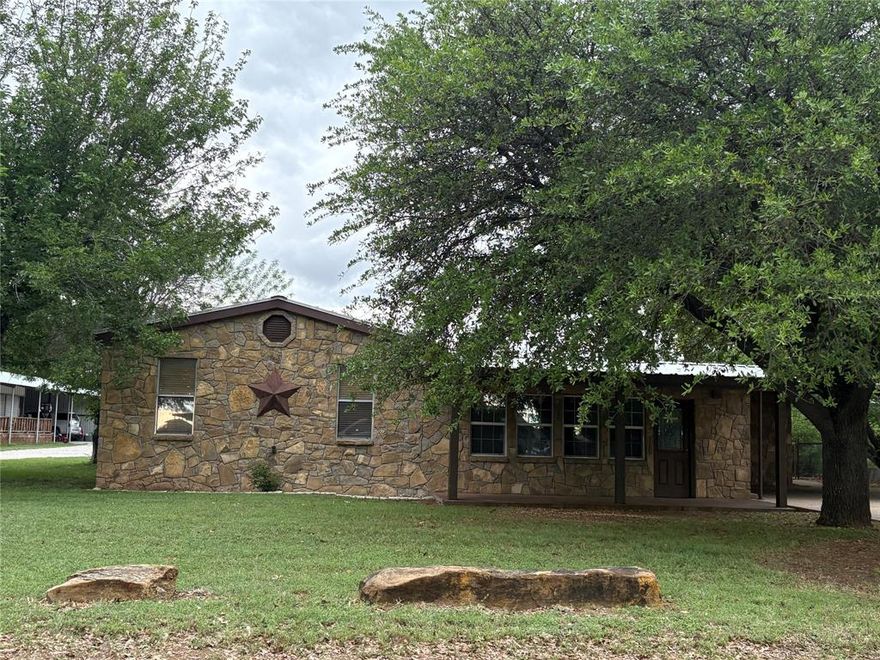Welcome to 210 Jones Rd at Possum Kingdom Lake. This 3 bed 2 bath property has it all as it is a well established family home. Inside the home you will open up to a nice, large living room, then stepping up to a beautiful kitchen and dining area. It has a designated laundry room, walk in pantry, large master bedroom with an ensuite including a big bathtub and walk in closet. What you will find outside just completes this property- 2 car attached carport, fenced in back yard, beautiful shade trees, detached 4 car carport and last but certainly not least, a 25x30 metal building shop with 2 roll up doors and a loft area for extra storage space. New indoor and outdoor AC units were installed in 2024. Located in a quiet neighborhood- still in the amazing Graford school district but only a few minutes drive to the lake for a beach day, you get the best of both worlds here!