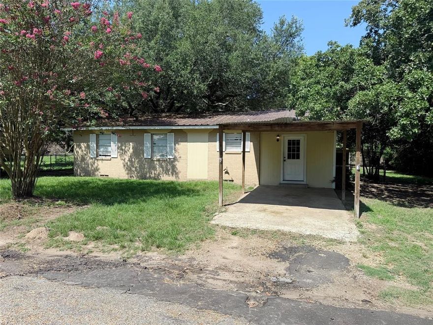 The home welcomes a thoughtful layout, offering a comfortable gathering spot waiting for your vision. Just steps away, the kitchen features practical cabinetry and ample countertop space, ready for your personal touches. Additional common areas provide room to create a cozy home. The primary bedroom offers privacy and space, while the other bedrooms are ready to be customized to your needs. Outside, the spacious lot and covered parking add convenience and versatility. Athens is a charming East Texas city known for its scenic beauty, community spirit, and proximity to Dallas about an hour drive away. This home offers a suitable foundation ready for your finishing care. Claim Your Piece of Texas!