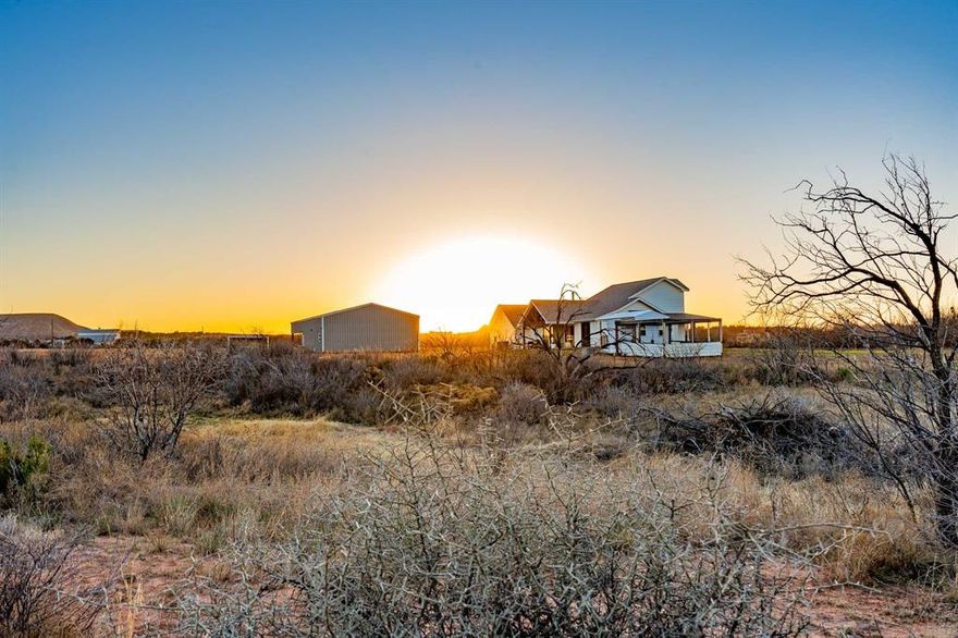 Endless West Texas sunsets and wide-open Abilene skies set the stage for this stunning 15+-acre, 5 bedroom ,3 bath retreat in Wylie West ISD. Tucked away at the end of a quiet county road, this custom farmhouse, built in December 2024, offers the peaceful living that defines life in Abilene, space to breathe, room to grow, and views that never get old.

Mornings begin with coffee on the porch as the horizon glows and the breeze rolls across open pasture. Fall evenings gather around the wood-burning stove, while long summer nights are spent outside under wide Texas skies watching the sun set over your land. Wildlife moves freely, ponds reflect the changing seasons, and the acreage invites hunting, livestock, gardening, or simply enjoying the freedom of owning your own piece of Texas.
Inside, the home feels refined yet welcoming. The kitchen was designed as a gathering place with natural quartzite countertops, farmhouse sink, gas range, and a generous walk-in pantry ready for canning season, bulk storage, or feeding a full house. The layout offers space for family, guests, and quiet evenings upstairs while maintaining an open, comfortable flow.

Built with intention, the home blends efficiency and durability with everyday comfort spray foam insulation, high-efficiency systems, tankless hot water, reverse osmosis drinking water, a water softener system, and thoughtful upgrades throughout.
The 40x40 shop with a 40z25 lean-to was built with vision for the future hobbies, equipment, expansion, or guest space. Livestock fencing, a custom chicken coop, underground utilities, and fiber optic internet allow you to enjoy country living without sacrificing connection.

More than land. More than a home. This is West Texas living at its finest. OWNER AGENT $3,000 landscape or concessions with accepted offer.