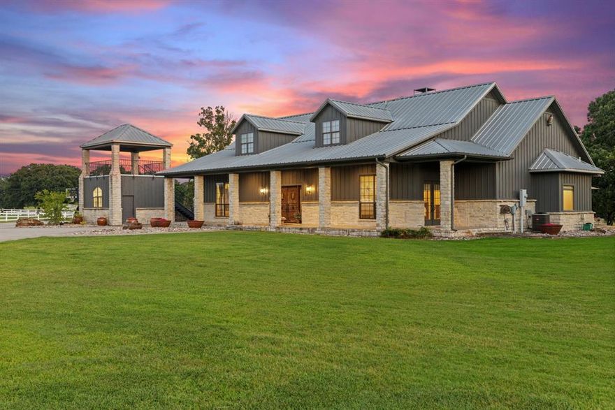 Welcome to Howdy Honey Ranch, a 30+ acre ranch estate brimming with charm, function, and flair. With majestic oak trees, luxury white vinyl fencing, and unforgettable equestrian facilities, this turnkey ranch is ready to welcome your vision whether that’s a working operation, dream retreat, or profitable short-term rental property. The ranch is conveniently located off of HWY 69 and 1 hour from Dallas.
The main home boasts over 3,945 sq ft with 3 spacious bedrooms, each with its own private en-suite, plus a guest half bath. Natural light pours in through large windows, highlighting tranquil pasture views and open-concept living that feels like home the moment you step inside. A separate 1 bed 1 bath suite above the detached garage adds extra flexibility which is ideal for guests or extended family. 
The PINK barn is a showstopper!! With 4 fully equipped stalls featuring automatic watering systems and stall mattresses. Above the barn is a fully furnished 1 bed 1 bath apartment. It’s the perfect space for a potential income opportunity either for Airbnb, a ranch hand, or guests seeking a stay they’ll never forget. 
Other improvements throughout the ranch include 4 cross-fenced pastures with automatic watering systems and a separate pasture that is barbed wire fenced for cattle. A professionally lit 120x240 riding arena provides the perfect space for safe, comfortable night-time riding, training, and events. There are three brand new 12x24 stalls located near the arena with their own private runs. The workshop conveniently located next to the barn allows for extra work space, tack room, tools, and storage. Two well-maintained ponds sit directly in the center of the property that is easily accessible from all areas, plus another pond in the back! Two ponds are roughly 20’ deep and are excellent for fishing or peaceful reflection. The backyard features a lighted, turf playground, offering kids a safe, fun play space just far enough from the home for added comfort.