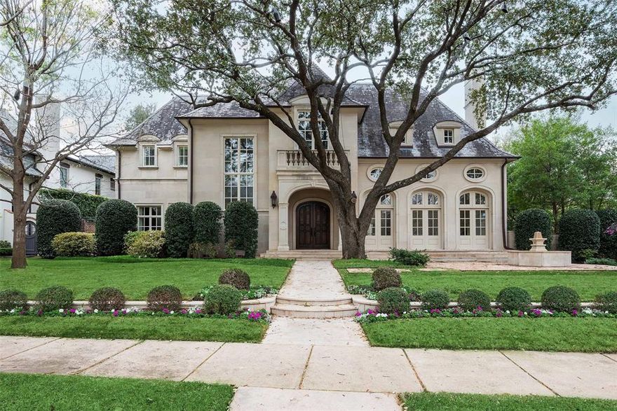 Perfectly situated at the southeast intersection of Lexington and Byron Ave, and in the very first installment of Old Highland Park, this prominent property has stood as a masterpiece for almost two decades. Constructed in the year 2008 with timeless materials and longevity in mind, Tatum Brown Homes set a new standard for home building at the time. The limestone façade foreshadows the quality within this fine French inspired home. With over 13,000 square feet the property is equipped to address important entertaining while the gentle scale of its rooms maintains an intimacy. The home is introduced by an impressive foyer which guides the eye down a magnificent corridor, lined with groin vaults. The two-story Living Room is appointed with cove ceilings, it seamlessly leads to the formal Dining Room, which accesses the west garden via three sets of French doors. The Catering Station is situated between the Dining Room and an open spaced Culinary Kitchen. Kitchen, Family Room, Breakfast area and Keeping Room are all designed to concentrate on many guests whereas the Library, Wet Bar, Wine Grotto (with Wine Vault) are directed toward more private gatherings. The Grotto serves as an excellent space for cards or Mahjong. Three half-baths accommodate the living areas. Outdoor porticos are protected by phantom screens; the south portico surveys the lawn and swimming pool; it features one of the home’s five fireplaces. Five Bedrooms and seven full baths are distributed throughout 2.5 floors; the primary suite is believed to house almost 1,800 square feet with a sitting room (fireplace), dual wardrobe closets, and a sumptuous bath. The first-floor bedroom duals as an office or as an Exercise Room, it is strategically situated with outdoor access to the heated pool and spa. The Media Room, appointed with a kitchen-bar and a full bath, is accessed either via an outdoor staircase or the back hall. It may also serve as guest quarters.