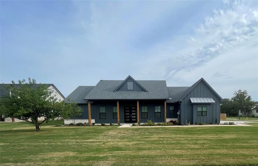 This 4-bed 2.5 bath modern farmhouse is a real showstopper. Board and batten siding with natural stone skirting on a corner has great curb appeal.  10 foot ceiling throughout, great room with statement Fireplace and gas logs, mounted flat screen tv above that comes with the home. Chef's kitchen features a walk-in pantry, Custom cabinets,  large prep island with seating for at least four, Pot Filler above 6 burner gas cooktop, electric wall oven and microwave. Master bedroom is situated on the back side of the home, away from the other bedroom double walk-in closets, bathroom with a large Shower and a free-standing jetted tub. The secondary bedrooms are located on the opposite side of the home with a separate bathroom. All bedrooms have ceiling fans and custom window shades.  Oversized covered back patio with stone fireplace is perfect for year round entertaining.  Backyard is fully fenced and sodded. Over half an acre in the acclaimed Glen Rose school district and community.