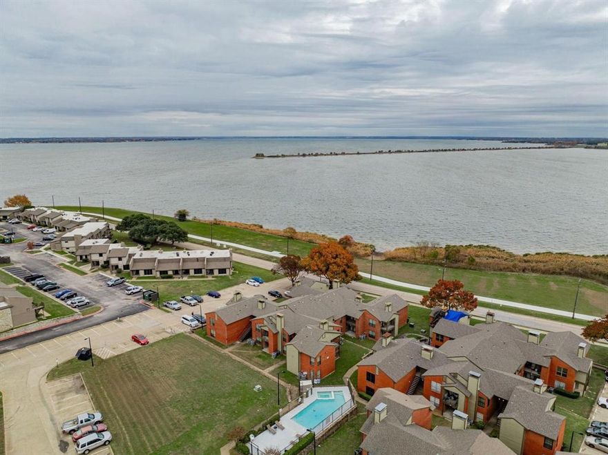 Nice updated condo with  Walking Distance to Lake Ray Hubbard & the Marina. Private and Cozy Upstairs End Unit, featuring 2 Bedrooms and 2 Baths, Living area boasts tons of natural light with balcony, brand new Luxury vinyl floors all through the house, updated kitchen with stainless steel appliances and new luxury quartz countertop.  Wall panel wet bar with beautiful chandelier perfect to entertaining friends and family.  Spacious bedrooms with plenty of storage will not disappoint!  Highway 30 is also at your convenience. Tile and vinyl Flooring throughout No carpet. Even a Community Pool. Close to Bass Pro, Restaurants, Shopping, and all that Lake Living Offers. Water is included in HOA fee . Buyer and Buyer agent to verify all information & HOA fees.