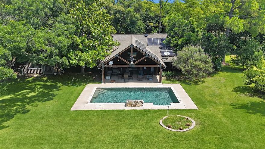 Welcome to this multigenerational property that is perfectly designed for comfort, function, and opportunity. Nestled behind a beautifully tree-lined driveway, this spacious home features expansive front and back porches that are ideal for relaxing or entertaining alongside the stunning pool. It also offers nature lovers many opportunities with all the wildlife, wild fruit bushes and trees, a creek and tons of land for livestock or gardening. There is plenty of room for an arena. The main house offers 4 bedrooms with 3.5 bathrooms, 2 living and 2 dining areas. The custom barndominium ,being the second home on the property, offers an open concept living and kitchen with 3 bedrooms and a large bathroom.  There is a large barn, 5 stalls, corral, and a vast pasture with a tank and well out in the pasture. With three water wells, agricultural tax exemption, and no known restrictions, this property offers true flexibility for a variety of uses. Bring all the animals and enjoy your own ranchette or make it into an income producing investment property. Additional features include a chicken coop, an indoor and outdoor dog kennel, a dedicated dog grooming space, and a large workshop. Whether you’re seeking a peaceful country lifestyle, a multigenerational retreat, a place to call home with multiple shops and plenty of room to add on or an investment property, the possibilities here are truly endless. So many possibilities with all the land and terrain. Game feeders, hunting blind, chutes gates, 3 safes, all tv's, washer and dryer, refrigerator, back patio furniture and front porch swing all convey. Come out to see what all this property has to offer.