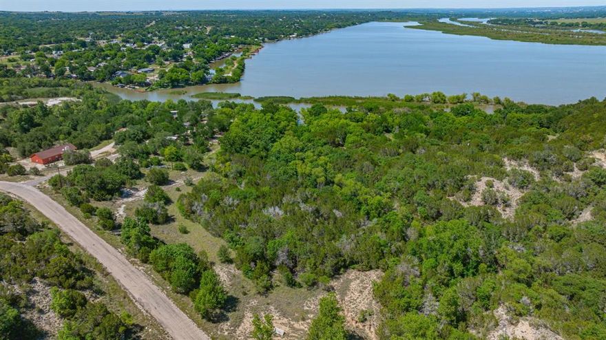 Rare opportunities like this don’t come around often on Lake Granbury. Spanning approximately 5 waterfront acres with an incredible 1,800 feet of shoreline, this property offers the kind of flexibility, privacy, and investment potential that buyers dream about. Whether you envision developing multiple luxury lakefront homes, creating an income-producing getaway, or building a private estate for your family, this property is ready to deliver.
Approximately 800 feet of reinforced seawall adds both functionality and peace of mind, while the expansive waterfront views create a stunning backdrop in every direction. The land offers multiple prime build sites with room to design something truly special — from modern lake homes to a legacy property meant to stay in the family for generations.
Already equipped with 3 RV hookups, the property is perfectly set up for weekend escapes, hosting friends and family, or living comfortably on-site while constructing your dream home. Imagine mornings with coffee overlooking the water, evenings around a fire pit, and direct lake access right outside your door.
Properties with this much shoreline, usable acreage, and development potential on Lake Granbury are exceptionally hard to find. Whether you're an investor, developer, or someone searching for an unmatched waterfront lifestyle, this property is a chance to create something extraordinary.
