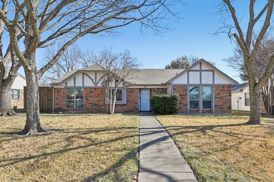 Charming single-story brick home nestled beneath mature shade trees in an established Duncanville neighborhood. 1318 Oak Run offers inviting curb appeal with classic Tudor-style trim accents, a welcoming front entry, and a spacious front yard with a long sidewalk approach. Inside, you’ll find a light-filled living area with vaulted ceilings, crown molding, and a cozy brick fireplace that serves as the focal point of the space. The open layout flows seamlessly into the dining area, creating an ideal setup for everyday living and entertaining. Wood-look flooring in the main living space adds warmth and durability, while tile flooring in the kitchen and dining areas provides easy maintenance. The kitchen features rich wood cabinetry, granite countertops, stainless steel appliances, and a modern tile backsplash. With ample cabinet storage and generous counter space, it is both functional and stylish. A convenient pass-through opening connects the kitchen to the living area, enhancing the open feel of the home. The primary suite and secondary bedrooms offer comfortable layouts with plenty of natural light. Bathrooms are well-appointed and designed for practicality. A dedicated laundry area adds convenience to daily routines. Step outside to enjoy the backyard space, perfect for relaxing, pets, or entertaining. The mature trees provide shade and privacy, while the brick exterior offers timeless appeal and low-maintenance living. Located in a quiet, established community with easy access to shopping, dining, schools, and major highways, this home combines comfort, charm, and convenience. Whether you’re a first-time buyer, downsizing, or adding to your investment portfolio, 1318 Oak Run is a wonderful opportunity to own a well-maintained home in the heart of Duncanville. Schedule your private showing today and discover all this home has to offer.