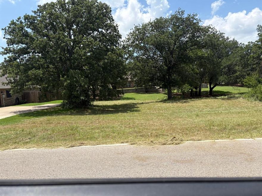 Seller is really motivated to sell fast , Located in the heart of Pecan Plantation, this generous one-third acre lot is the perfect place to build your dream home. Bring your builder and plans—this property is ready for someone with a vision. Set within a secure, gated community along the Brazos River and near Lake Granbury, Pecan Plantation offers a lifestyle unlike any other. Residents enjoy access to a private marina, championship golf course, multiple swimming pools, tennis courts, walking trails, a shopping center with its own grocery store, an on-site gas station, and even a private airport. For aviation enthusiasts, some lots near the airport allow for private hangars alongside your home. Select properties also permit RV garages, offering great flexibility. Utilities are convenient, with water and cable at the front of the lot, and septic needed. This is a rare chance to own land in one of Granbury’s most unique and amenity-rich communities.