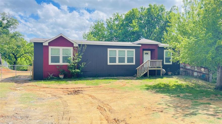 Discover the perfect blend of comfort, space, and convenience in this beautifully maintained 2020 double-wide manufactured home offering 3 bedrooms, 2 full baths, and 1,560 square feet of thoughtfully designed living space in Mansfield, Texas.

Situated on a spacious 0.82-acre lot and zoned to highly rated Mansfield ISD schools, this property provides the ideal balance of peaceful country living with easy access to city amenities. Built in 2020, the home features a modern open-concept layout that seamlessly connects the living area, dining space, and kitchen—perfect for everyday living and entertaining alike.

The kitchen offers ample cabinetry, generous counter space, and room to gather, while the private primary suite includes a spacious bedroom and en-suite bath designed for relaxation. Two additional bedrooms provide flexibility for guests, a home office, or growing households.

The property is fenced, offering privacy, security, and room to enjoy the outdoors. It has Co-op water and septic, adding convenience and long-term value. With no HOA and no deed restrictions, you have the freedom to personalize the property to fit your lifestyle—whether that means adding a workshop, garden, or additional outdoor features.

The lot offers a mix of gravel and open space with native grasses, providing plenty of room for recreation, parking, or future improvements. Conveniently located near major roadways, shopping, dining, and Mansfield’s expanding amenities, this property combines rural breathing room with suburban accessibility.

Opportunities to own newer construction on almost an acre of land and no restrictions are rare. This is your opportunity to experience everything this Mansfield property has to offer.