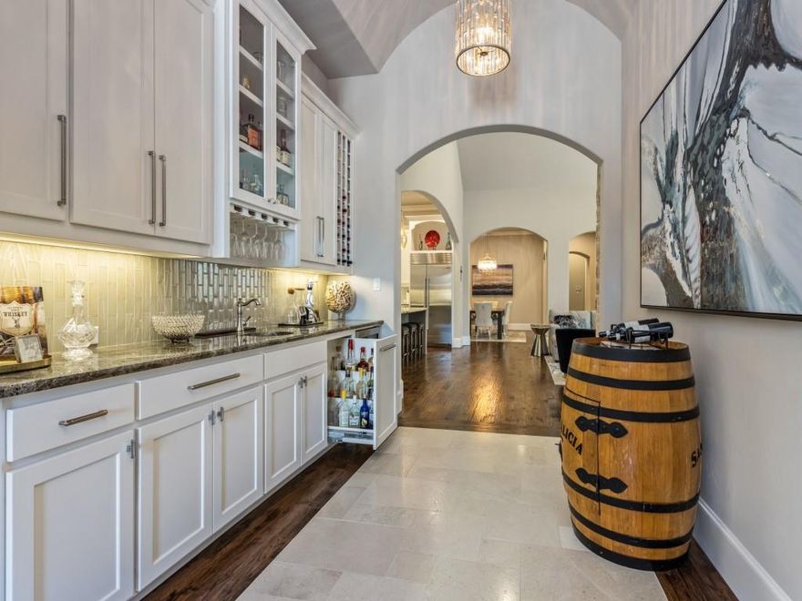 Extraordinary when a Single Story home comes on the market in the prestigious gated, guarded community of Normandy Estates.  Even more rare when the home has a highly transitional style with an open floor plan.  From the moment you walk in, the design and architecture reveals a home that is designed for both entertaining and a sanctuary for your personal retreat. Combining these attributes with its functionality such as a butler pantry with a quaint office workspace so close to the utility room makes this home so very special and well thought out. All of this in a relaxed environment as the home is bathed in natural light. The Master bedroom is spacious and the Master bath is stunning with a very well appointed closet. The outdoor covered patio is ideal for leisurely outdoor living, summer or winter with phantom screens, and a fireplace as well as a mounted outdoor heater. Extended patio with motorized louvers that keeps out the rain or blocks the sun. Did I mention the putting green?