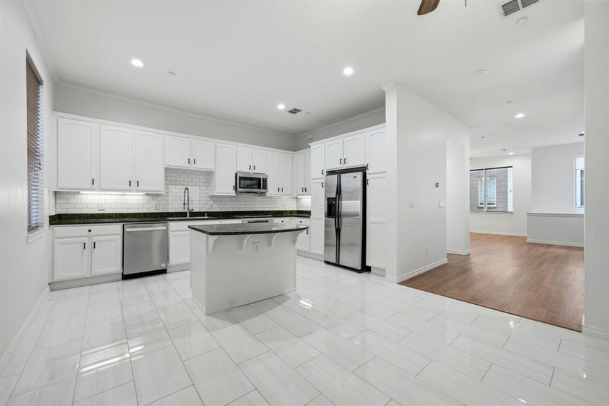 This recently renovated condo in the highly sought-after Knox Henderson area offers 2 bedrooms, 2 full baths, and 1 half bath in 2,049 square feet of thoughtfully designed living space. The first level welcomes you with a guest bedroom with ensuite bath and provides convenient access to the attached 2-car garage. Upstairs, the second level is bright and open, featuring an updated kitchen open to the dining area. The generous kitchen with crisp white cabinetry boasts a center island, gas cooktop and ample cabinet space. The light-filled living room with a fireplace is accented by beautiful wood floors. A convenient half bath completes the second level. The third level is dedicated to the expansive primary suite, complete with a sitting area. The beautifully renovated bathroom includes a soaking tub, large separate shower with marble tile, dual sinks and a walk-in closet. Full-size utility closet is conveniently located next to the primary suite. A hallway door opens to a private deck, offering a quiet outdoor retreat. Located near dining and shopping in the Knox Henderson area and just steps from the Katy Trail, this home offers a location that can’t be beat! Crisp and clean, this home is ready for you to move right in!