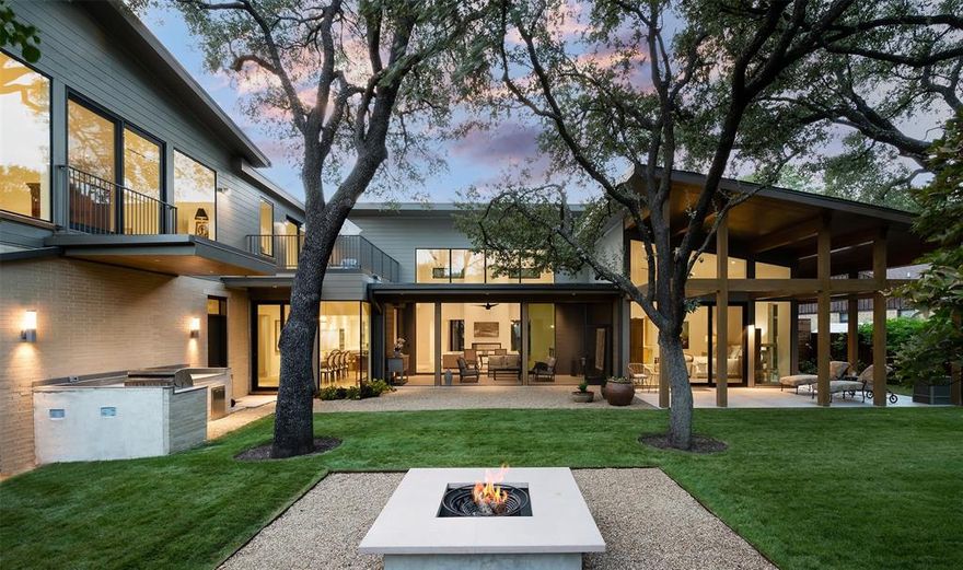 A Modern Perfection with sleek custom touches on a tree covered .39 acre lot. This builder's masterpiece offers bright open spaces, soaring windows with picturesque views of the gardens. Chef’s kitchen open to living room with professional-grade Miele appliances, oversized quartz island & 2 dishwashers. Separate catering kitchen is an entertainer's delight. Primary suite with spa-like bathroom, floor to ceiling windows luring your eye to the bronze water fountain in private English garden. Large walk-in closet, private powder rm with bidet. A covered wraparound patio with SPA ready connections. Main floor includes the primary suite, 3 add. bedrooms, 3.5 baths, air-cooled wine cellar, study, screened-in patio, safe room, and 3 car garage with workshop. Upstairs has add. living space, dining, kitchenette, bedroom, laundry, and outdoor patio. Ideal for guest, professional office with private entrance. A favorite location in Preston Hollow! Designed by SMH architects. Attic space galore!