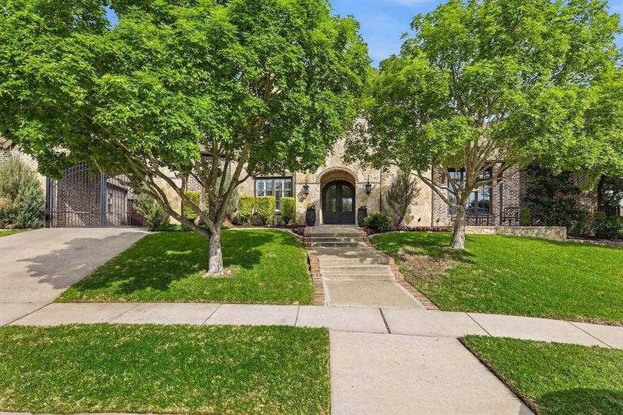 Luxury estate on an oversized lot with exceptional privacy featuring a 4 bed, 4.1 bath main house plus a fully equipped attached 2 bed, 2 bath guest house, ideal for multigenerational living. Stepping through the iron double doors you’re welcomed by beautiful white oak floors and a sweeping staircase. A formal dining room sits to the left and a study to the right with French doors and custom built-ins. Open-concept living area with a stone-faced gas log fireplace, expansive picture windows overlooking the backyard paradise, and a bonus wet bar with wine fridge and ice maker. The kitchen has been extensively updated with white cabinetry, honed Taj Mahal quartzite counters, stainless appliances including double ovens and a warming drawer, gas cooktop, built-in fridge, custom apron sink, and a walk-in pantry. Designer lighting and plantation shutters continue throughout the home. The primary suite is privately positioned on the right side of the home with backyard views and direct outdoor access, featuring dual sinks, a tub, walk-in shower, and spacious walk-in closet. The first floor also includes a guest bedroom with ensuite bath, an additional half bath, and a laundry room with ample cabinetry and a sink. Upstairs offers a game and media room with a wet bar, along with two additional bedrooms, each with ensuite baths. A gated motor court leads to the three-car garage and provides access to the attached guest house with private entrance, offering a living room with sliding doors to its own patio, dining area, full kitchen with pantry, laundry, and two bedrooms, each with ensuite baths. The resort-style backyard features a stunning pool and spa, a covered patio with a double-sided fireplace, built-in grill and refrigerator, an additional pergola that creates a secondary seating area, fire pit, and outdoor shower, all surrounded by stamped concrete decking that extends the living space outdoors.