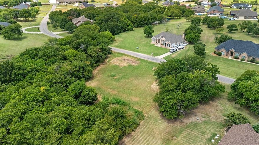 Build Your Dream Home on this Gorgeous 1.26 acre Homesite! This Beautiful Homesite is located in the Highly Sought after Neighborhood, Woodlands of Preston. Neighborhood is located in the Top Rated Gunter ISD. This Homesite is One of the Few Remaining in the Neighborhood. The Homesite is a Corner Lot. It has a Serene Creek runs thru the south side of the property. Mature trees run along the side and back of the homesite. There is a pad site prepared for future construction. Many custom homes built all around this homesite. This is a Rare Opportunity to Build Your Dream Home in this Established Custom Neighborhood!  Drive By and See For the Possibilities for Yourself!!!