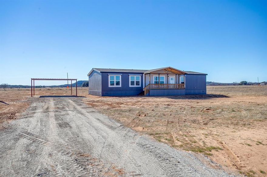 New Construction 4-bedroom, 2-bath home is situated on a rural one-acre lot just outside the historic town of Mineral Wells, TX—only minutes from downtown shopping, dining, and amenities. Offering the perfect blend of affordable country living and modern convenience, this property also includes a 20x20 carport for covered parking and added functionality.

Inside, an inviting open-concept floor plan creates the ideal space for everyday living and entertaining. The heart of the home is the spacious kitchen, featuring a large center island perfect for gatherings. The living room is anchored by a rustic-yet-refined entertainment center and a cozy electric fireplace wrapped in barnwood accents, adding warmth, charm, and character.

The private primary suite offers a true retreat, complete with a generous walk-in closet and a beautifully finished walk-in shower adorned with elegant ceramic tile. Three additional bedrooms provide flexibility for family, guests, or a home office.

Step outside and enjoy the peaceful setting from the expansive covered front and back porches. The one-acre lot backs up to serene rural land, offering exceptional privacy and beautiful views. A high-yield water well adds long-term value and significant savings.

Whether you’re raising a family or seeking a quieter pace of life, this home delivers the best of both worlds—tranquil country living with easy access to city conveniences.